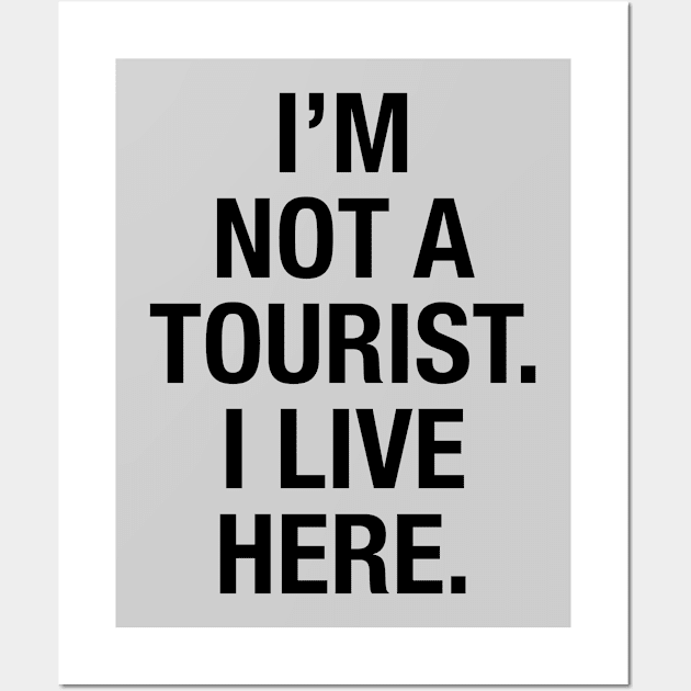 I'm not a tourist. I live here. (black) Wall Art by LetsOverThinkIt